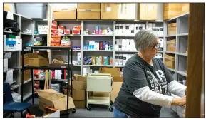  ?? NWA Democrat-Gazette/CHARLIE KAIJO ?? Counselor Brenda Walkenbach opens the door to a food pantry on Friday at New Technology High School in Rogers.