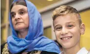  ?? DAVID LIPNOWSKI / THE CANADIAN PRESS ?? Nofa Zaghla is reunited with her 12-year-old son Emad Mishko in Winnipeg on Thursday. Emad was rescued by Iraqi forces in July after being held captive by ISIL.