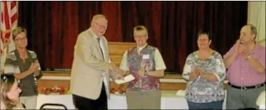  ?? Submitted photo ?? DONATED ... The Rev. Julie Bergdahl, pastor of St. Michael’s Lutheran Church in Sellersvil­le, third from left, presents a $20,000 check to Pennridge FISH President Ted von Mechow, second from left, to jump-start a major capital campaign for the local...