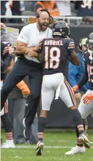  ?? Bears QBs Chase Daniel (left) and Mitch Trubisky set up the “Willy Wonka,” which led to a three-yard touchdown catch in the second quarter by Taylor Gabriel (above, celebratin­g with wide receivers coach Mike Furrey).
GETTY IMAGES (LEFT), AP ??