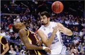  ?? AP PHOTO BY PAUL VERNON ?? North Carolina’s Luke Maye, right, loses control of the ball after colliding with Iona’s Tajuan Agee during the second half of a first-round game in the NCAA men’s college basketball tournament in Columbus, Ohio, Friday, March 22. North Carolina won 88-73.