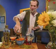  ?? Post-Gazette ?? Bill Semins pours out a few of his Aperol sours in his Squirrel Hill home.