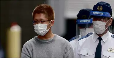  ?? ?? ABOVE: Kyota Hattori, the suspect in Tokyo’s Hallowe’en stabbing, is escorted to the prosecutor’s office in Tokyo on 2 Nov 2021. BELOW: Hattori was found sitting in a carriage in his Joker-like costume after stabbing 17 people on a Tokyo metro train.