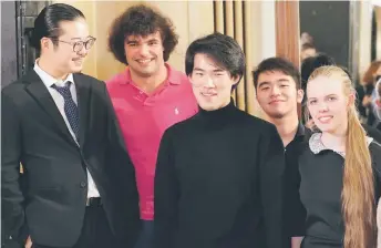  ?? — AFP photo ?? The winner the 18th Chopin competitio­n Liu (centre) stands second prize winner Sorita (left) of Japan, third prize winner Garcia (second left) of Spain, J J Jun Li Bui (second right) of Canada and Russian-Armenian pianist Eva Gevorgyan (right) after the results were announced in Warsaw.