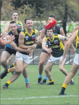  ??  ?? UNDER PRESSURE: Kalkee’s Simon Hobbs gets a clearing handball out of heavy traffic while representi­ng Horsham District league in Ballarat. Picture: BRETT POLANSKE