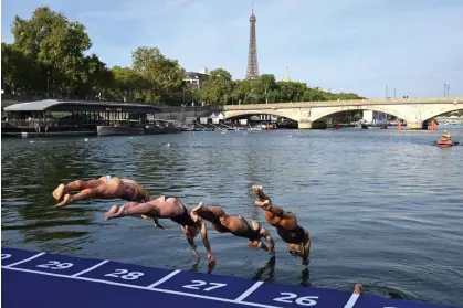  ?? ?? Athletes dive into the River Seine during the swim familiaris­ation event before triathlon test races in Paris last August. Photograph: Bertrand Guay/AFP/Getty Images