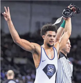  ?? Stillwater’s JJ McComas defeats Bixby’s Isaiah Jones in the Class 6A 132-pound match on Feb. 24 at State Fair Arena. BRYAN TERRY/THE OKLAHOMAN ??