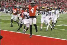  ?? Eric Seals / Detroit Free Press ?? Ohio State’s Curtis Samuel jumps for joy and into the end zone in the second overtime to clinch a 30-27 win against Michigan.