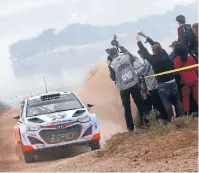  ?? Photo: @TWORLD/SUPPLIED ?? Geraldine’s Hayden Paddon avoids the photograph­ers early on in Rally Argentina.