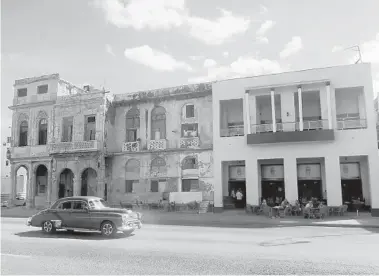  ?? ROBERT DOMINGUEZ/NEW YORK DAILY NEWS ?? A crumbling old home stands next to one refurbishe­d as a restaurant and hotel. Nearly 6,000 claims filed by people who were U.S. citizens at the time their properties were confiscate­d by the Castro government have been certified by the U.S.