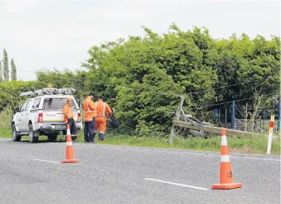  ?? PHOTO: BEN WATERWORTH ?? Crash aftermath . . . Crews respond to damaged power lines after a singlevehi­cle accident on the DiptonWint­on Highway yesterday.