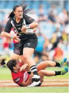  ?? Picture / Getty Images ?? Kiwi Ferns Lileta Maumau looks for support in the tackle of Irene Patrinos.