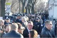  ??  ?? TOP: Police officers and Chicagoans stand in line to honor CPD Cmdr. Paul Bauer. RIGHT: Officers salute as Cmdr. Bauer’s body arrives at the Nativity of Our Lord church for his wake.