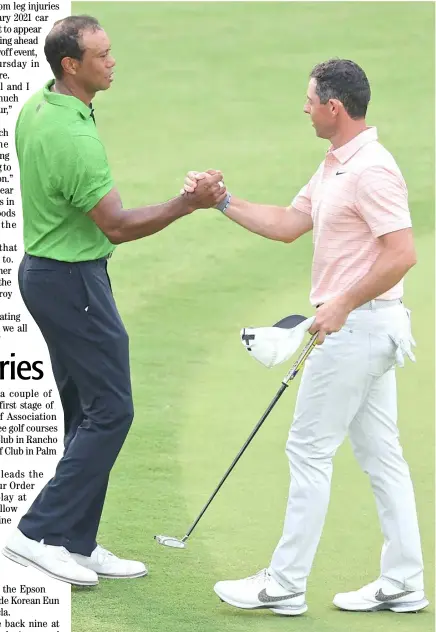  ?? CHRISTIAN PETERSEN/AGENCE FRANCE-PRESSE ?? TIGER Woods (left) and Rory McIlroy are joining hands in the PGA Tour’s fight with LIV Golf.