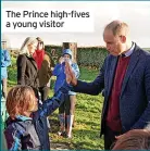  ?? ?? The Prince high-fives a young visitor