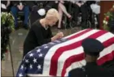  ?? J. SCOTT APPLEWHITE — THE ASSOCIATED PRESS ?? Cindy McCain, wife of Sen. John McCain, R-Ariz., leans over his flag-draped casket in the U.S. Capitol rotunda during a farewell ceremony, Friday in Washington. The six-term Republican senator, who lived and worked in the nation’s capital over four decades, is lying in state under the U.S. Capitol rotunda for a ceremony and public visitation.