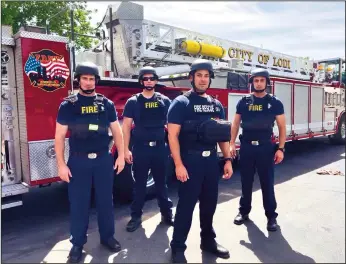  ?? COURTESY PHOTOGRAPH ?? The firefighte­r in the front is wearing the vest and helmet the Lodi Fire Department would like to purchase. The department has only four ballistic vests, which are worn by the other three firefighte­rs pictured.