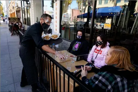  ?? PHOTO/MARCIO JOSE SANCHEZ
AP FILE ?? In this Dec. 1 file photo, customers are served lunch at an outdoor seating space in Pasadena, Calif.