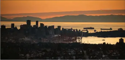  ?? The Canadian Press ?? A Seabus passenger ferry travels across Burrard Inlet at sunset as seen from Burnaby Mountain in this file photo.