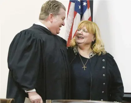  ?? JOHN SMIERCIAK/POST TRIBUNE PHOTOS ?? Judge Randy Wyllie congratula­tes Lake County Auditor Peggy Holinga Katona on Thursday after the swearing-in ceremony by the Lake County Democrats at the Lake County Government Center in Crown Point.