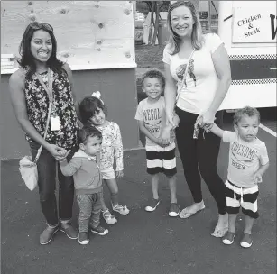  ?? Photo by Ernest A. Brown ?? Nisha Marnane, with her children Logan, 2, and Avery, 4, of North Smithfield, and friend Tata Pina, with her children Maddox, 4, and Jameson, 2, of Cumberland, check out the food court at Autumnfest Friday night