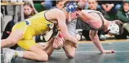  ?? Brian A. Pounds/Hearst Connecticu­t Media ?? Newtown’s Marc Maurath, left, defeats Xavier’s Maximus Morse to win the 145-pound weight class at the CIAC Class L wrestling finals on Satureday in Guilford.