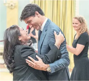  ?? JUSTIN TANG/THE CANADIAN PRESS ?? Mary Ng and Prime Minister Justin Trudeau hug after she was sworn in as Minister of Small Business and Export Promotion during a swearing in ceremony at Rideau Hall Wednesday.