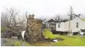  ?? ?? UPROOTED – A tree sits uprooted and the roof is ripped off a home belonging to Johnny Carte on Lookout Road in Hico, W.VA., Wednesday, April 3, 2024, after a storm hit the area the day before. (Rick Barbero/the Register-herald via AP)