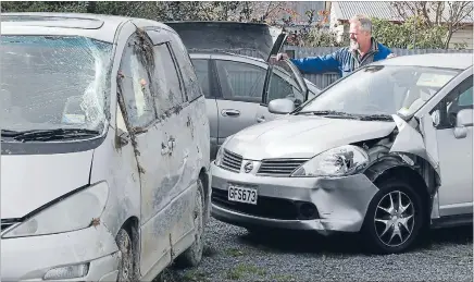  ?? Photo: JOHN BISSET/FAIRFAX NZ ?? Whoops: Peter Barnett of Geraldine Salvage with three of the cars written off by Asian tourists.