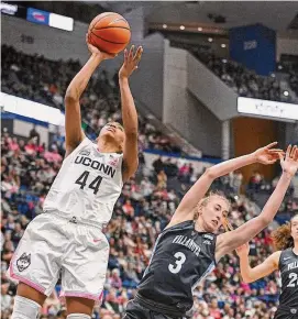  ?? Jessica Hill / Associated Press ?? UConn’s Aubrey Griffin (44) goes up for a basket while fouled by Villanova’s Lucy Olsen (3) in the second half on Sunday.