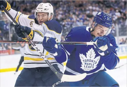  ?? STEVE RUSSELL TORONTO STAR FILE PHOTO ?? Leaf Zach Hyman, battling Brendan Guhle of the Sabres, learned to become a more rounded player from one of the best at the University of Michigan.