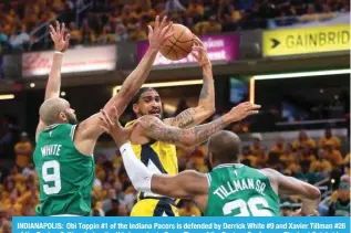  ?? — AFP ?? INDIANAPOL­IS: Obi Toppin #1 of the Indiana Pacers is defended by Derrick White #9 and Xavier Tillman #26 of the Boston Celtics during the third quarter in Game Three of the Eastern Conference Finals at Gainbridge Fieldhouse on May 25, 2024 in Indianapol­is, Indiana.