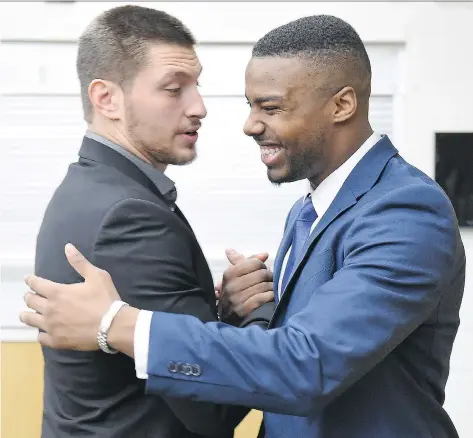  ?? DON HEALY ?? Newly signed Saskatchew­an Roughrider­s Justin Capicciott­i, left, and Shamawd Chambers greet each other in the Riders dressing room at Mosaic Stadium in Regina on Thursday.