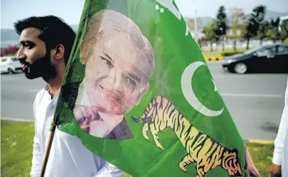  ?? [AFP/Aamir Qureshi] ?? Ein Anhänger mit dem Banner der Muslimliga und dem Konterfei von Shehbaz Sharif.