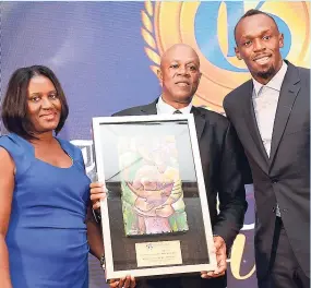  ??  ?? Gleaner Man of the Year, the legendary Usain St Leo Bolt (right), with his parents Wellesley and Jennifer, who were awarded by the Gleaner Honour Awards selection committee for ‘Exemplary Parental Support for a Jamaican Icon’ at The Jamaica Pegasus...