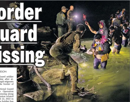  ?? ?? DANGEROUS JOURNEY: Border agents help asylum-seekers wade through the Rio Grande into the United States from Mexico last month — an increasing reality that has now led to a missing Texas National Guard soldier.