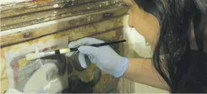  ??  ?? Nathalie Debono treating the wall paintings of the Chapel of Palazzo De la Salle (©Department of Conservati­on and Built Heritage, University of Malta)