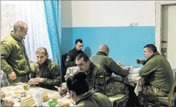  ??  ?? UKRAINIAN military medics eat breakfast at the Avdiivka City Hospital. As the closest medical facility to the front line, the community hospital became a makeshift military hospital soon after the fighting started.