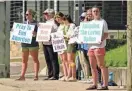  ?? ROGELIO V. SOLIS/AP ?? Protesters stand outside the Jackson Women’s Health Organizati­on clinic in Jackson, Miss., holding signage that opposes abortion. The clinic is the only facility that performs abortions in the state.