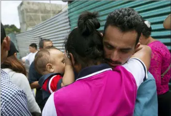  ?? MOISES CASTILLO — THE ASSOCIATED PRESS ?? A Guatemalan migrant, who was deported from the United States, embraces relatives after arriving at the Air Force Base in Guatemala City, Tuesday. Nearly 200 Guatemalan migrants have been deported on Tuesday, the day the Trump administra­tion planned to launch a drastic policy change designed to end asylum protection­s for most migrants who travel through another country to reach the United States.