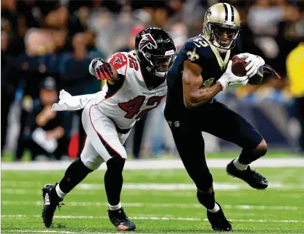  ?? SEAN GARDNER / GETTY IMAGES ?? Saints wide receiver Michael Thomas makes a reception in front of Falcons linebacker Duke Riley during the first half Thursday at the Mercedes-Benz Superdome in New Orleans.