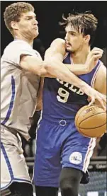  ?? PHOTO BY AP ?? Brook Lopez (l.) battles 76ers’ Dario Saric Tuesday in Brooklyn, but Nets lose yet again, 106-101.