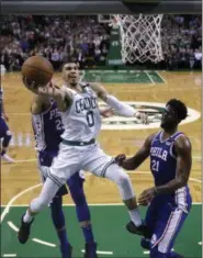  ?? CHARLES KRUPA — ASSOCIATED PRESS ?? Celtics forward Jayson Tatum drives to the basket against the 76ers during the second half of Game 5.