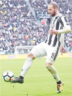  ??  ?? Higuain kicks the ball during the Italian Serie A football match against Udinese at the Juventus stadium in Turin in this March 11 file photo. — AFP photo