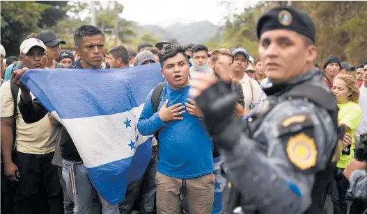  ?? Photo / AP ?? Honduran migrants are stopped at the Guatemalan border on their push for the US.