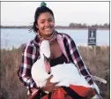  ?? Josh Spector / Associated Press ?? This Nov. 5 photo provided by Josh Spector shows Ariel Cordova-Rojas with Bae, a female mute swan, as the swan is rescued in the Jamaica Bay Wildlife Refuge, in the Queens borough of New York.