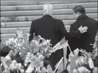  ?? AP/ANDREW HARNIK ?? President Donald Trump and Chinese President Xi Jinping walk together during today’s welcoming ceremony at the Great Hall of the People in Beijing. Trump said he was “having a great time” in China.