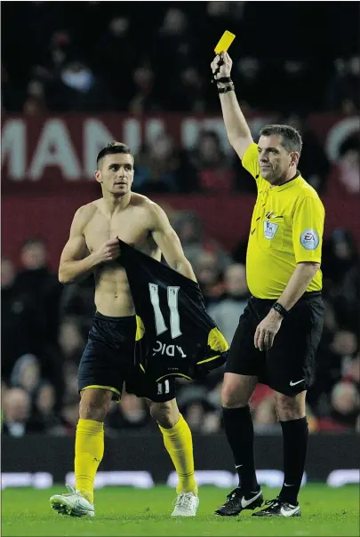  ?? — GETTY IMAGES ?? Referee Phil Dowd shows the yellow card to Southampto­n’s Serbian midfielder Dusan Tadic for removing his shirt to celebrate his goal against Manchester United on Sunday.