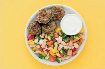  ??  ?? Greek-spiced lamb cakes with cucumber, tomato and radish salad.