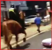  ??  ?? UNSTABLE: Fan in blue swings a punch at horse and gets chased – straight into riot cops